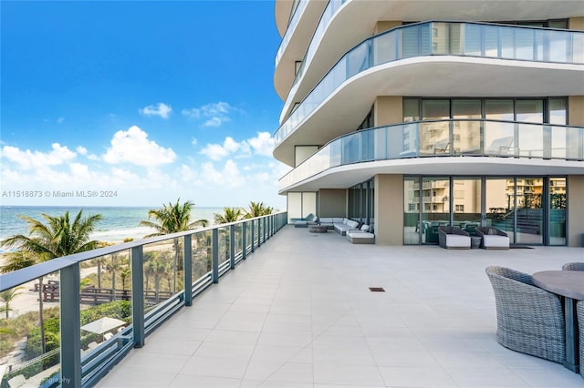 balcony featuring an outdoor hangout area and a water view