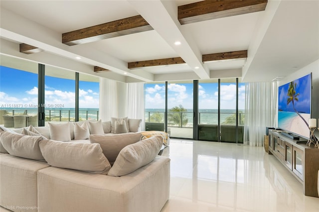 living room featuring beamed ceiling, floor to ceiling windows, light tile flooring, and a water view