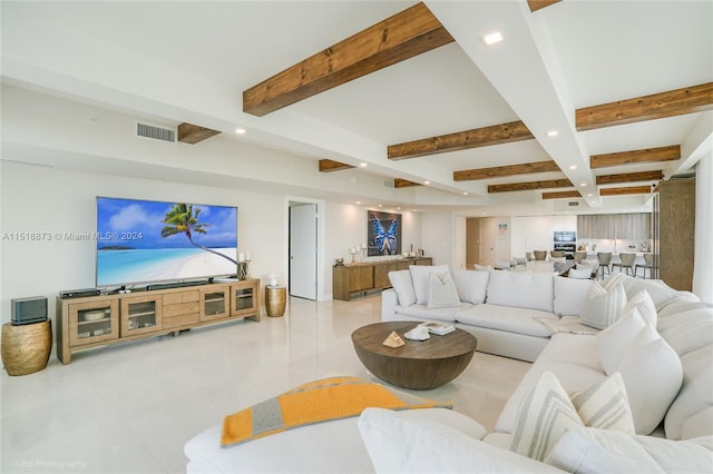 living room with light tile flooring and beamed ceiling