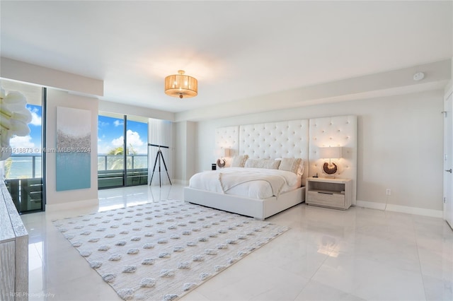 bedroom featuring access to exterior and light tile floors