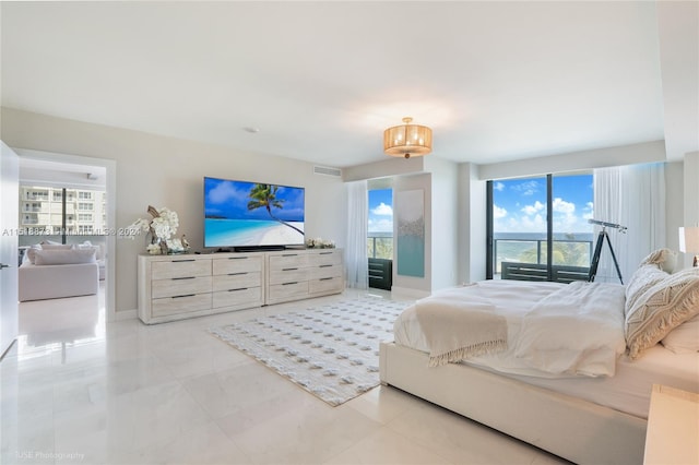 bedroom featuring light tile flooring and multiple windows