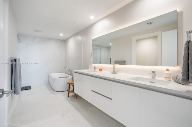 bathroom featuring tile floors, tile walls, and dual bowl vanity