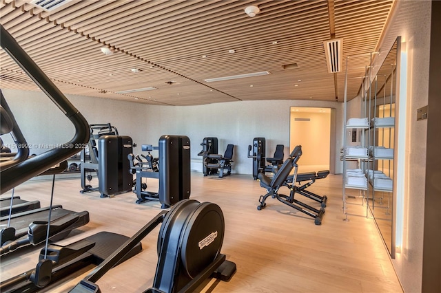 workout area with light hardwood / wood-style floors