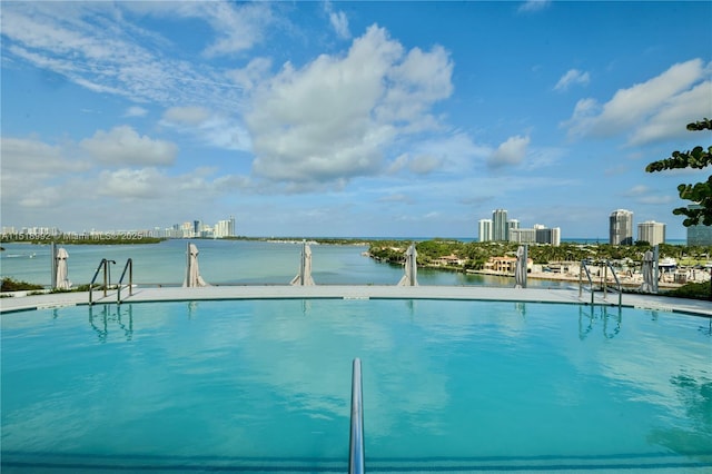 view of pool featuring a water view