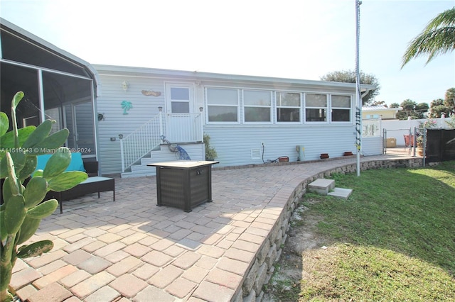 back of property with a patio area, fence, and a lawn