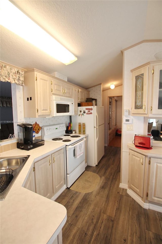 7950 W Hwy 78 W, Okeechobee, FL 34974 - kitchen featuring white appliances, dark wood-style flooring, light countertops, a textured ceiling, and glass insert cabinets