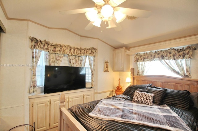 bedroom featuring ornamental molding, vaulted ceiling, and a ceiling fan