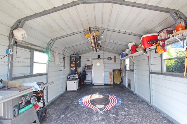 garage with metal wall and a garage door opener