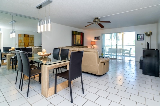 tiled dining area featuring a textured ceiling and ceiling fan