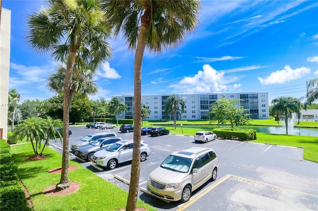 view of car parking with a lawn