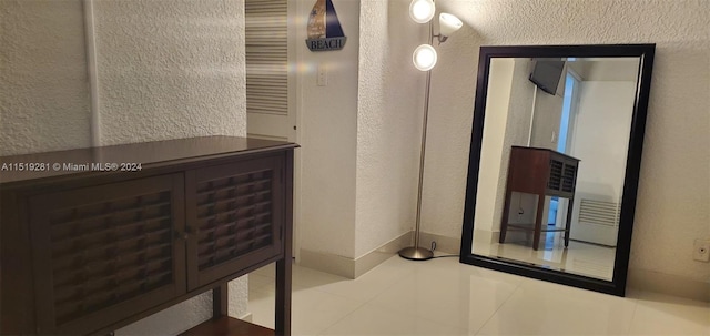 hallway featuring light tile floors