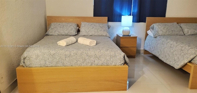 bedroom featuring light tile flooring