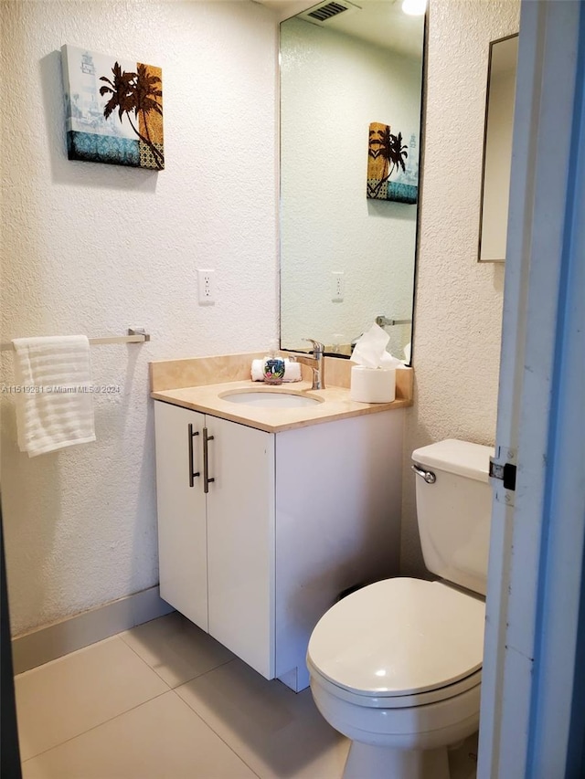 bathroom featuring tile floors, toilet, and vanity