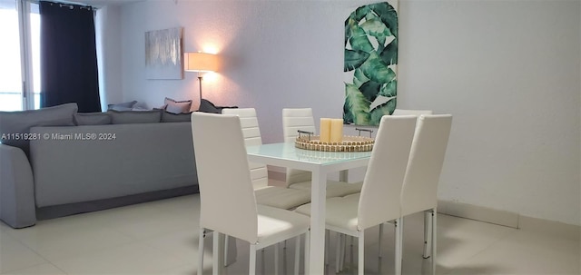 dining space featuring light tile flooring