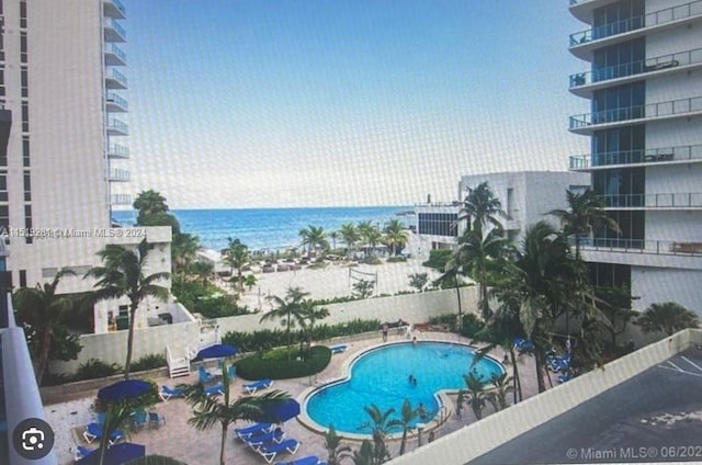 view of swimming pool featuring a water view