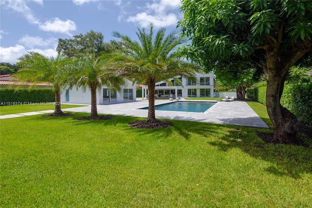 view of swimming pool with a yard and a patio area