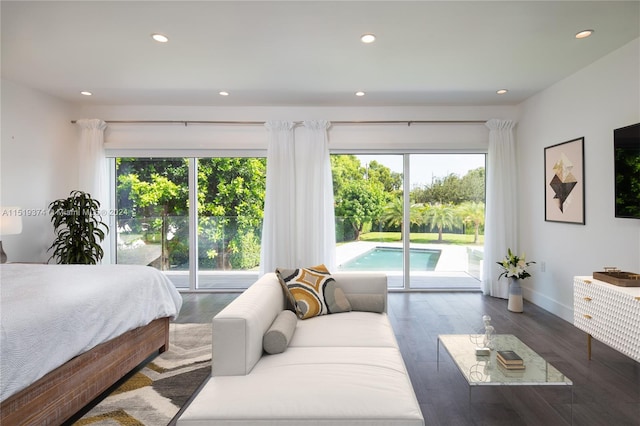bedroom with access to exterior and dark wood-type flooring