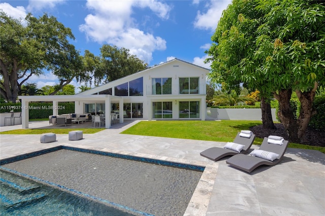 rear view of property featuring outdoor lounge area and a patio