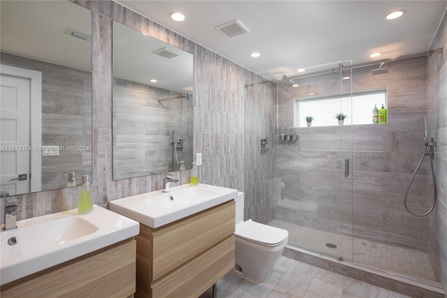 bathroom with tile walls, toilet, an enclosed shower, tile flooring, and oversized vanity