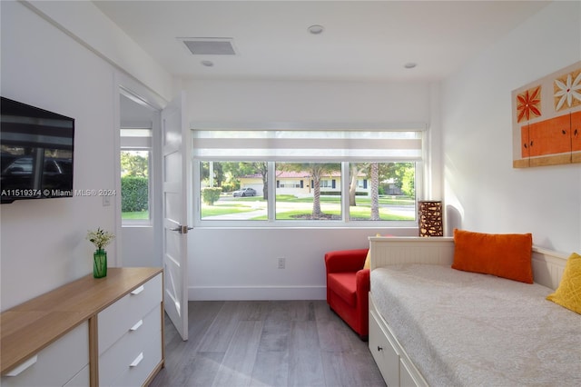 bedroom featuring multiple windows and light hardwood / wood-style floors