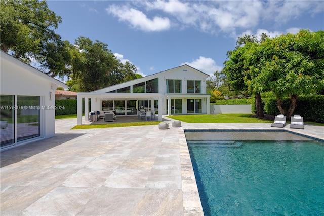 view of pool featuring a lawn and a patio area