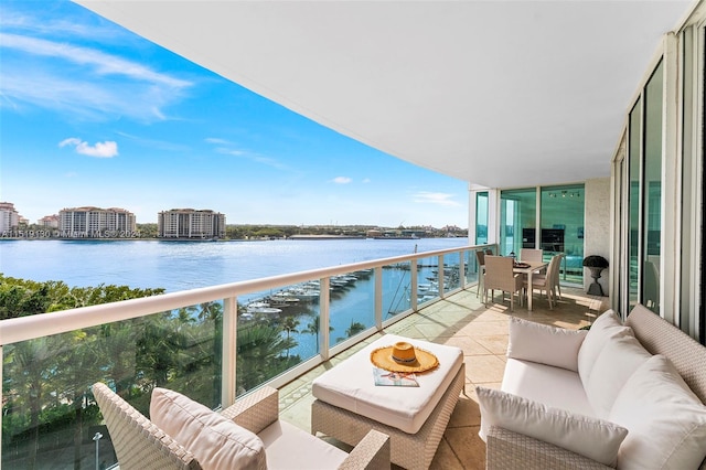 balcony with a water view and an outdoor living space