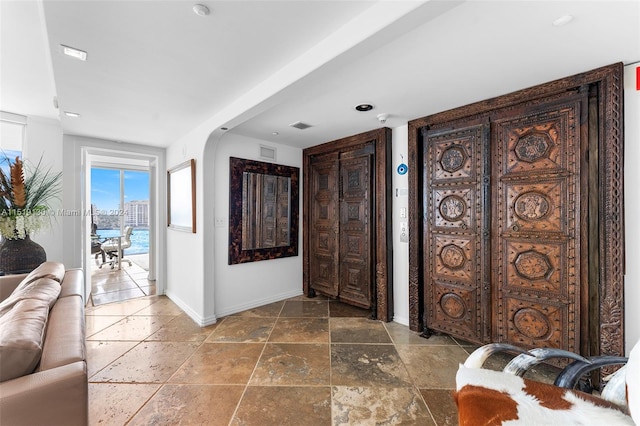 tiled foyer with a water view