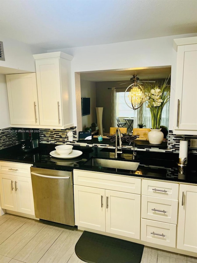 kitchen featuring sink, white cabinets, a chandelier, and dishwasher