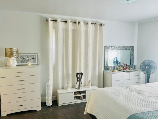 bedroom with dark hardwood / wood-style flooring