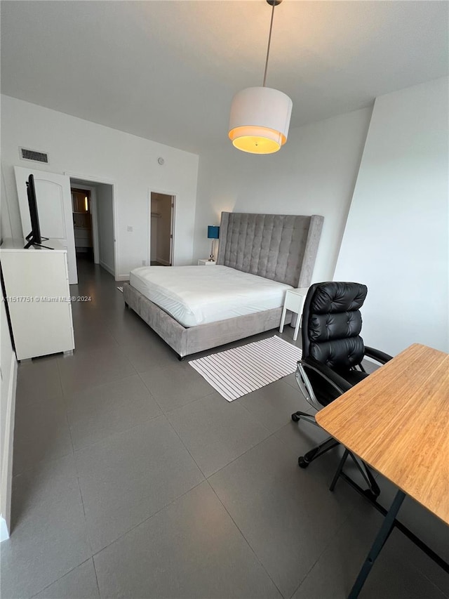 bedroom featuring dark tile floors