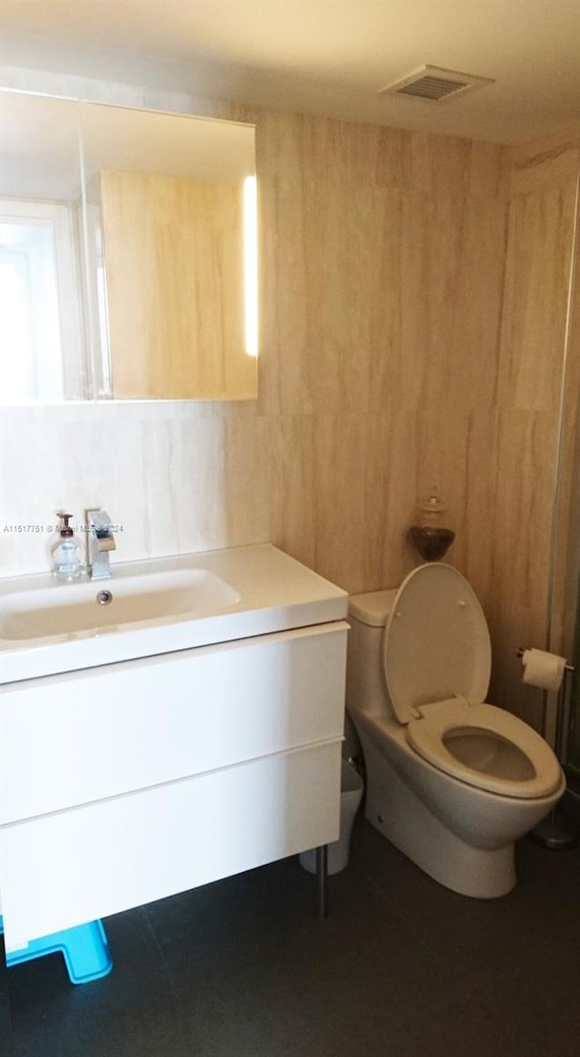 bathroom featuring toilet and vanity