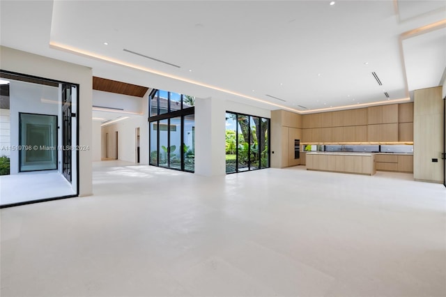 unfurnished living room with concrete flooring