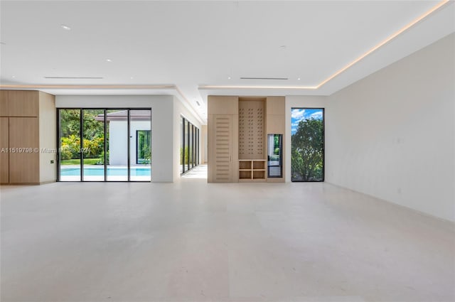 unfurnished living room with finished concrete flooring