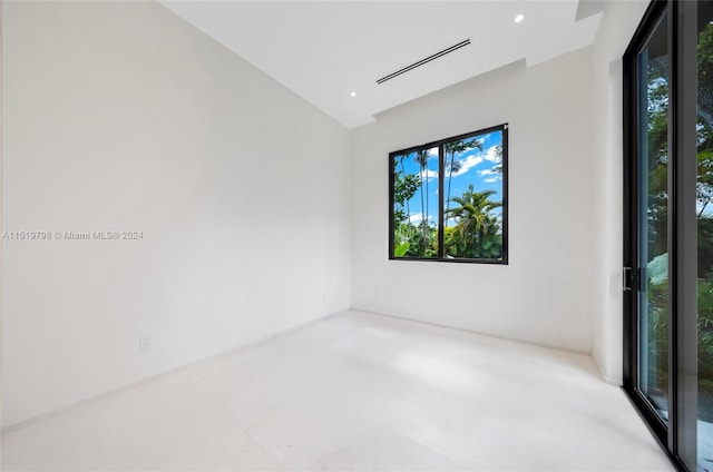 spare room featuring visible vents, recessed lighting, and lofted ceiling