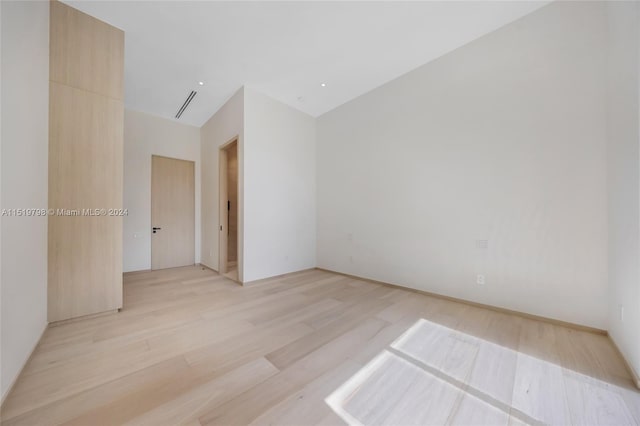 unfurnished room featuring light wood-type flooring and visible vents