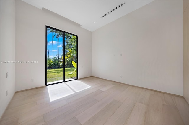 spare room featuring visible vents and light wood-type flooring