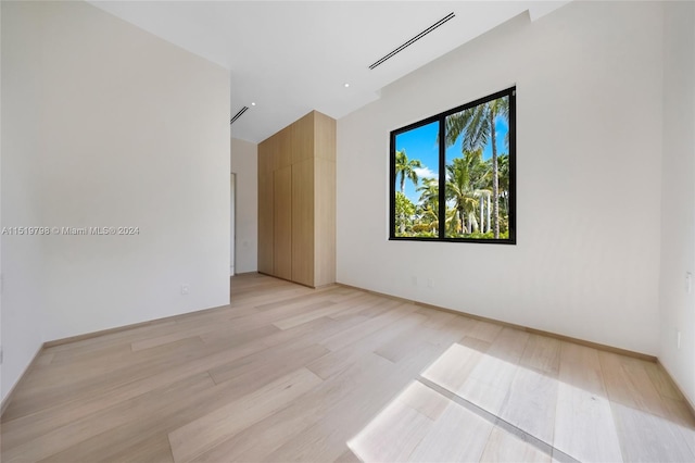 unfurnished room with visible vents and light wood-style flooring