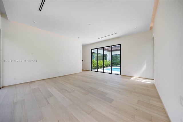 empty room featuring visible vents and light wood finished floors