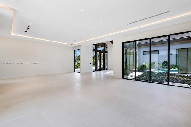 unfurnished room with visible vents and a raised ceiling