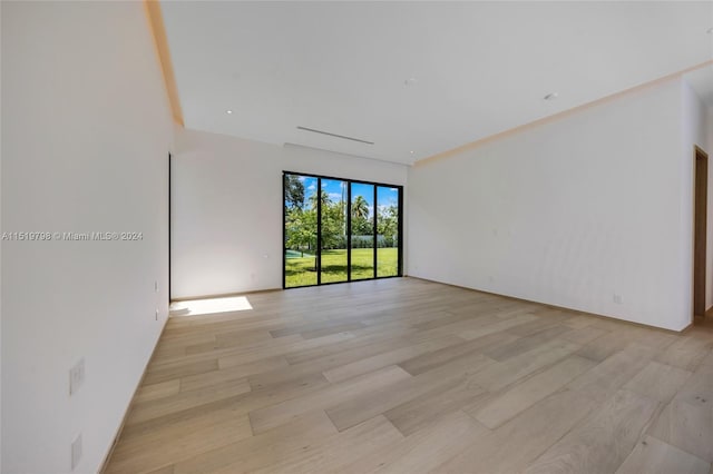 spare room with light wood-style floors