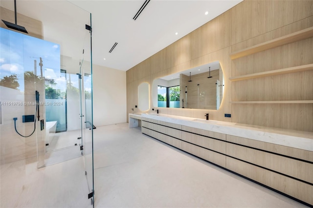 full bathroom featuring double vanity, finished concrete floors, a freestanding bath, and a stall shower