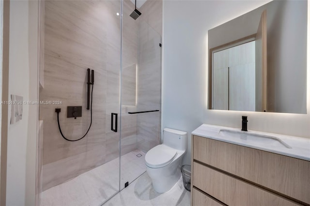 bathroom featuring vanity, toilet, and a stall shower