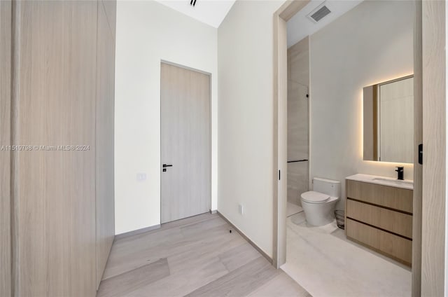 full bathroom featuring visible vents, toilet, wood finished floors, baseboards, and vanity