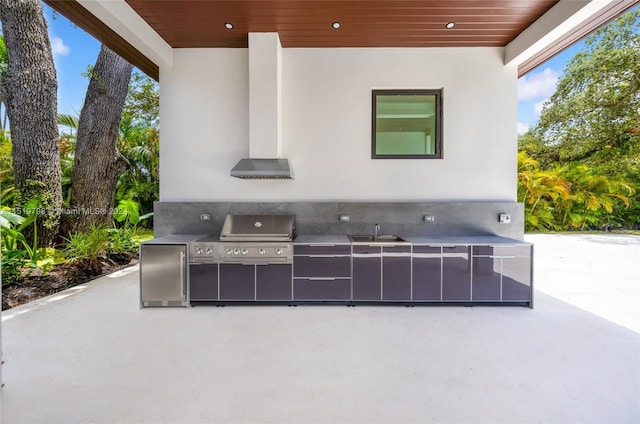 view of patio with area for grilling, exterior kitchen, and a sink