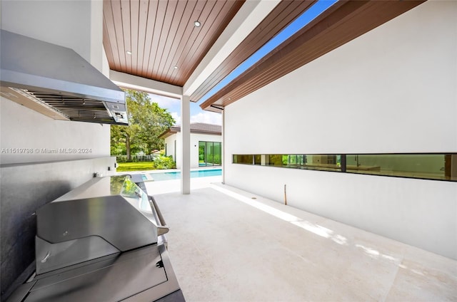 view of patio with grilling area and an outdoor pool