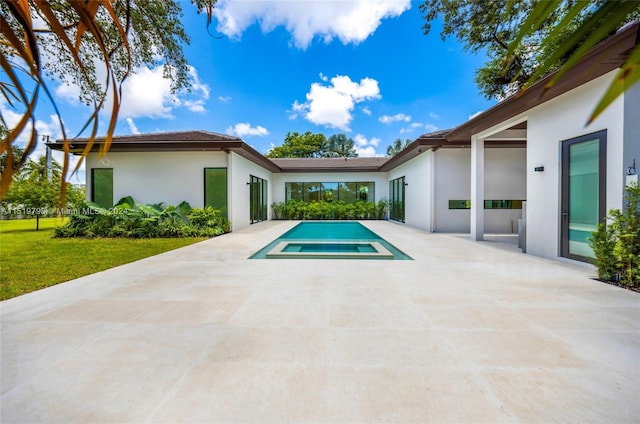 outdoor pool with a yard and a patio