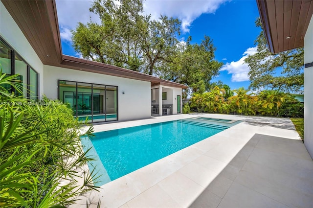 view of swimming pool with a patio area, a fenced in pool, and a hot tub