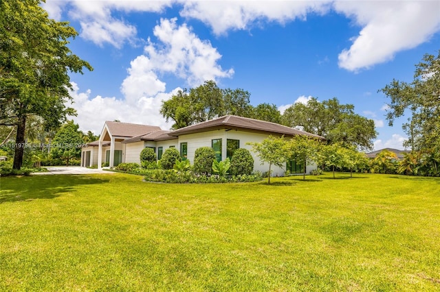 view of home's exterior featuring stucco siding, a lawn, concrete driveway, and an attached garage