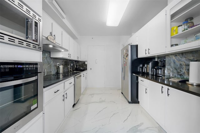 kitchen with backsplash, appliances with stainless steel finishes, white cabinets, and light tile floors