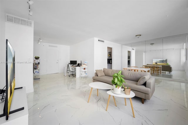 living room with rail lighting and light tile flooring